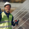 Engineer in a white helmet. Man near solar panel.